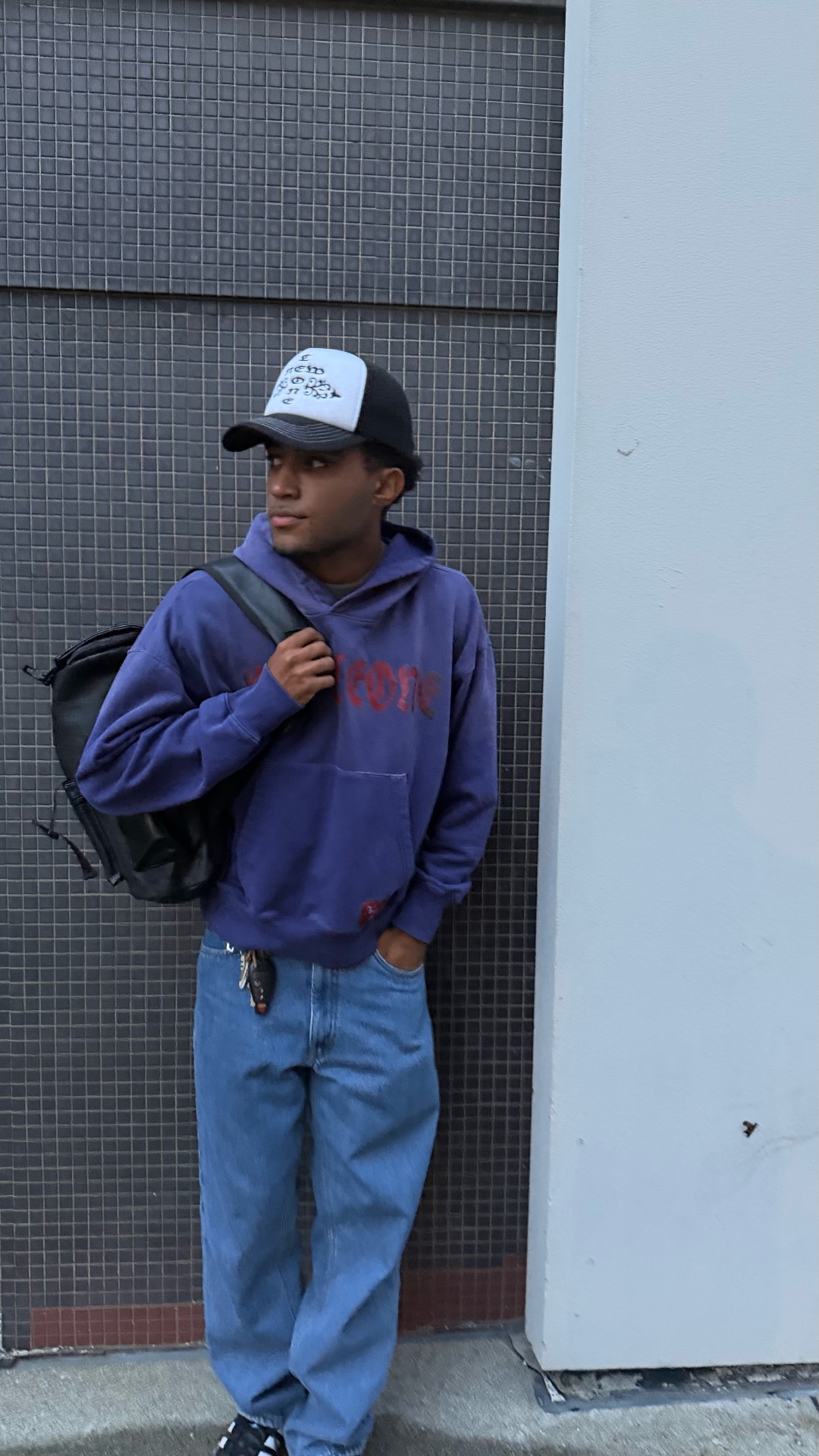 Purple hoodie, brick wall